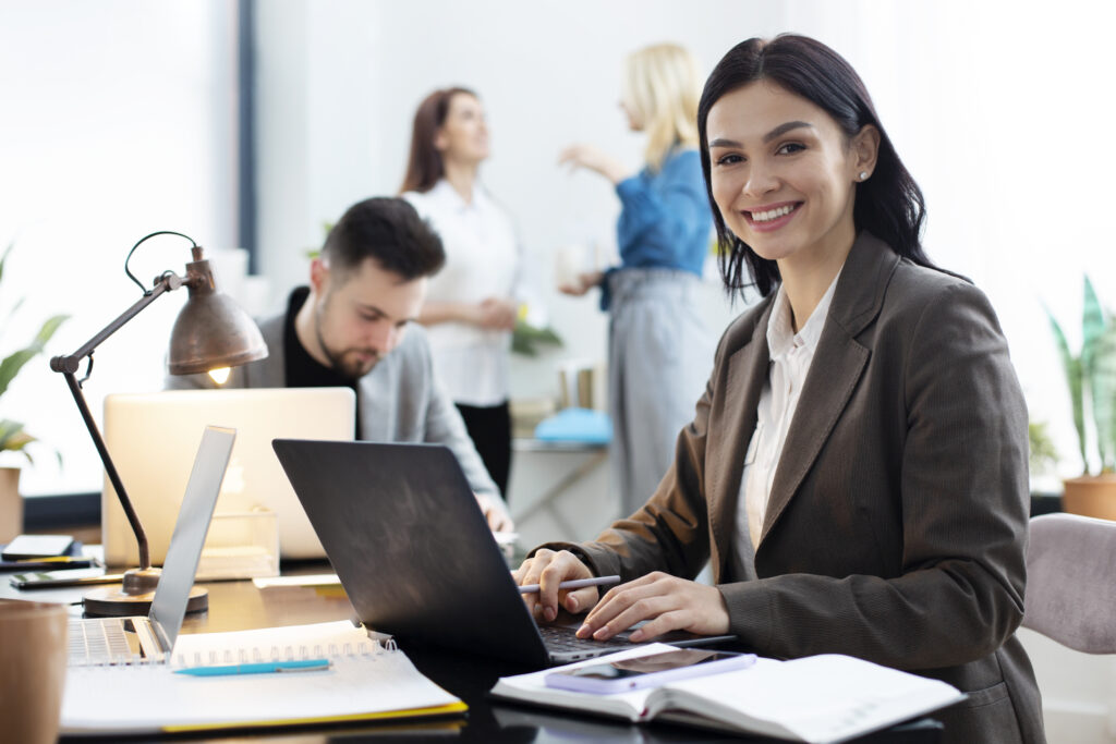 medium shot woman working laptop